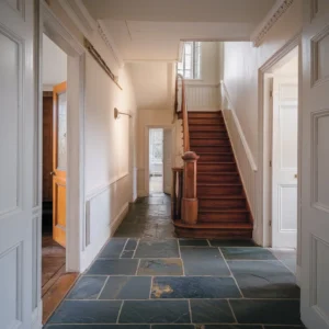 Victorian slate tiles laid in a traditional hallway, showing natural texture and aged stone finish typical of period properties